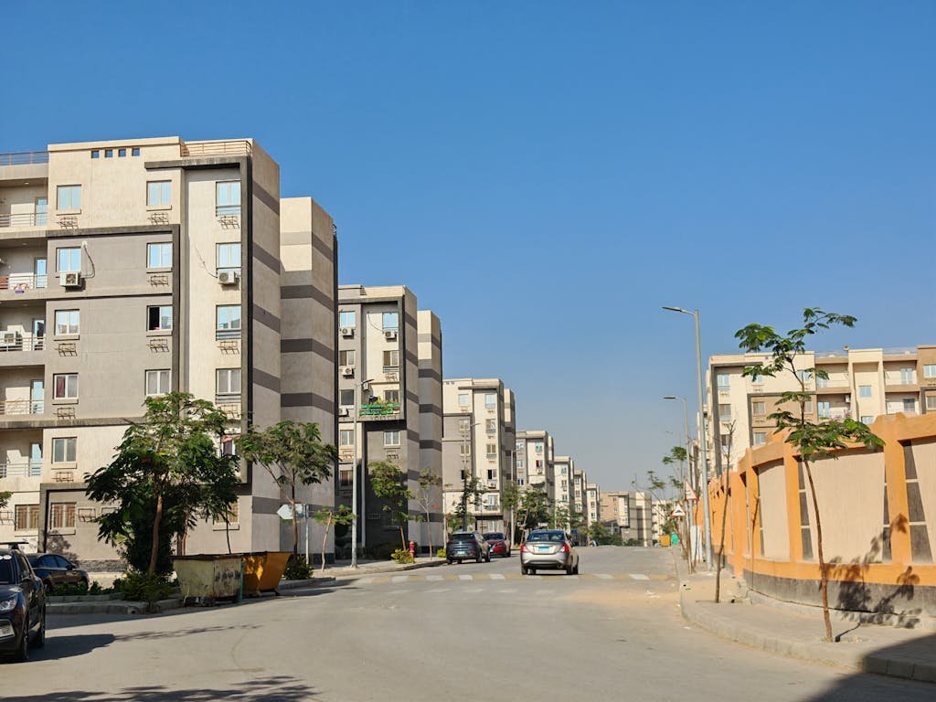 A bright sunny day view of modern apartment buildings on a quiet street.