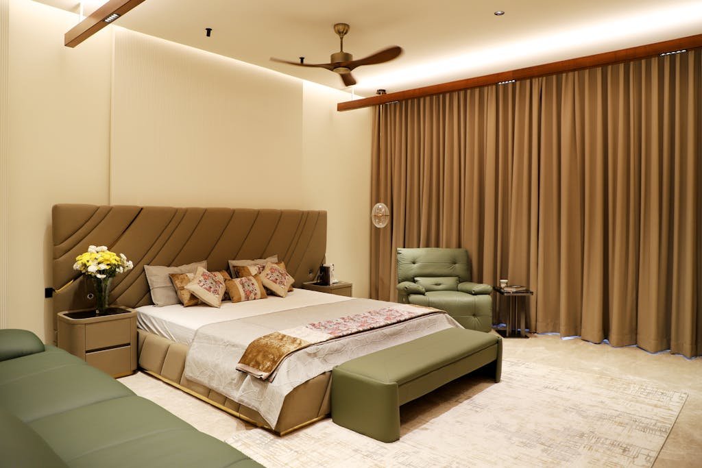 A cozy, well-furnished modern bedroom with elegant decor and soft lighting.