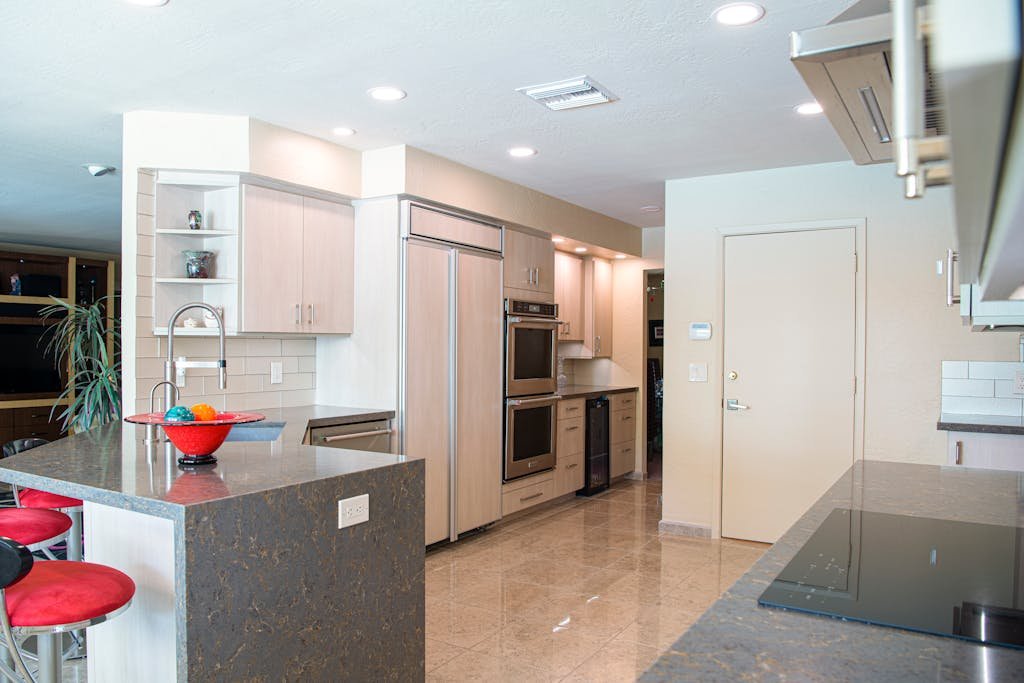 Contemporary kitchen with modern appliances and elegant detailing, featuring a spacious layout.