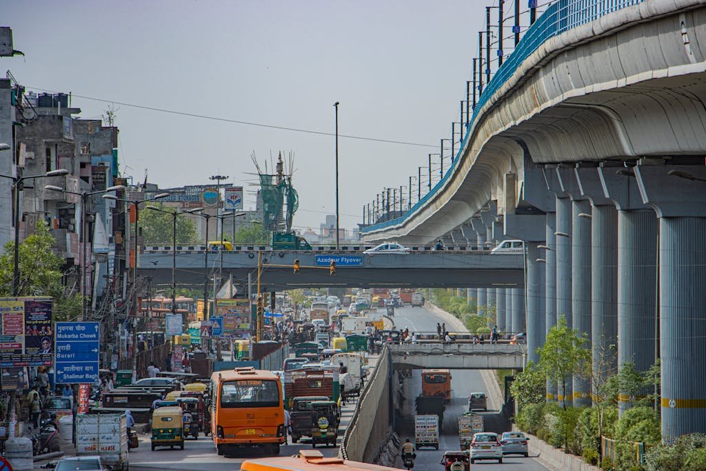 View of a busy road in Delhi featuring the Azadpur Flyover and local traffic.